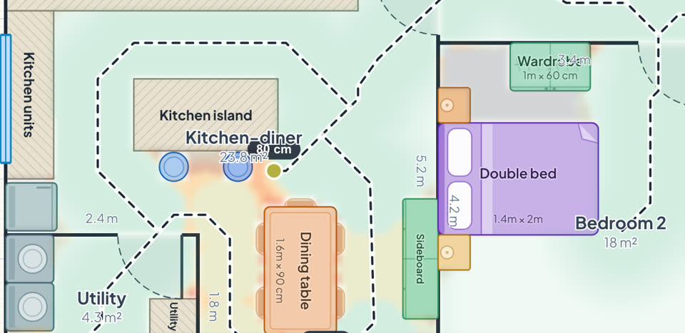 Close-up of the kitchen-diner and bedroom 2 with every chair tucked in and every door shut: an 80 cm squeeze between the island stools and the dining table glows amber, and the rest of the floor is green